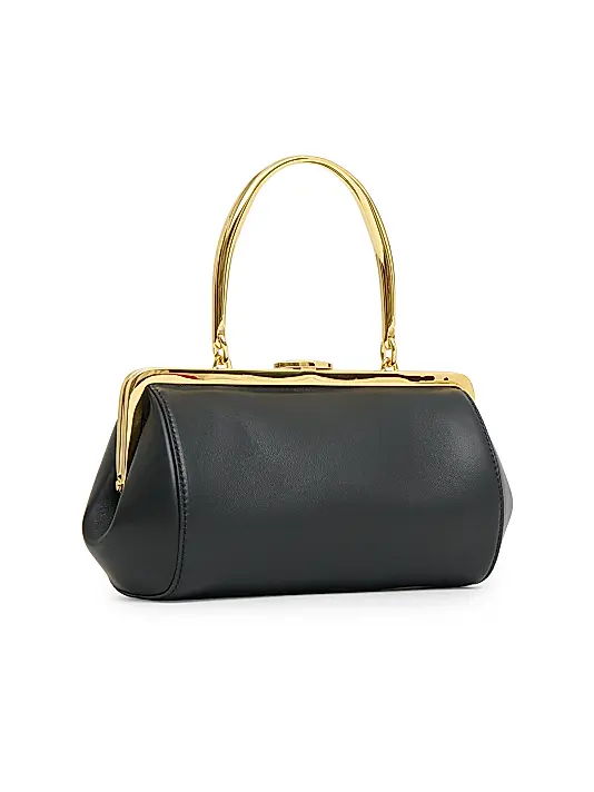 Formstabile Mini‑Handtasche mit goldener Rahmenverzierung, Druckknopf und Obergriff